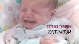 newborn lays in swing seat crying