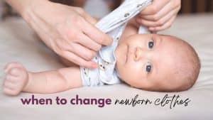 title image for the post how often should you change newborn clothes shows a small baby lays down looking at the camera as an adult pulls the baby's shirt down